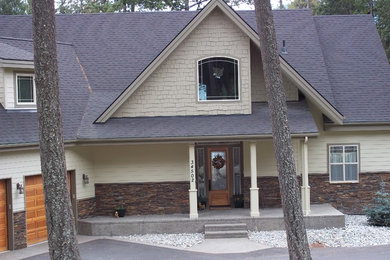 Large mountain style beige two-story concrete fiberboard and clapboard exterior home photo in Other with a shingle roof and a black roof
