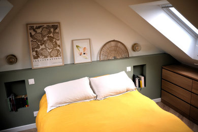 This is an example of a medium sized mediterranean bedroom in Other with laminate floors, beige floors and green walls.