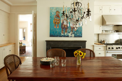 Enclosed kitchen - large farmhouse u-shaped medium tone wood floor enclosed kitchen idea in Chicago with a farmhouse sink, white cabinets, solid surface countertops, gray backsplash, subway tile backsplash, stainless steel appliances, an island and shaker cabinets
