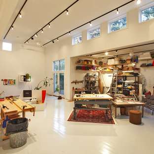 This is an example of an expansive modern home studio in Bridgeport with white walls, painted wood flooring and white floors.