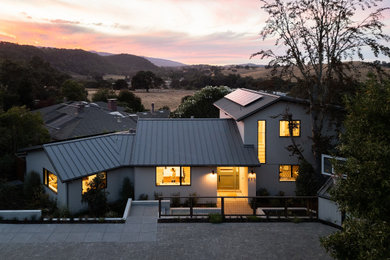 Inspiration for a contemporary white two-story wood exterior home remodel in San Francisco with a metal roof and a gray roof
