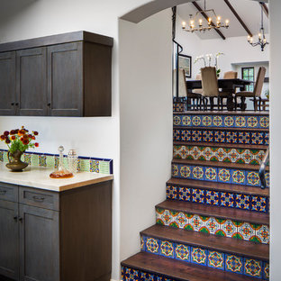 Photo of a large mediterranean straight metal railing staircase in Santa Barbara with terracotta treads and terracotta risers.