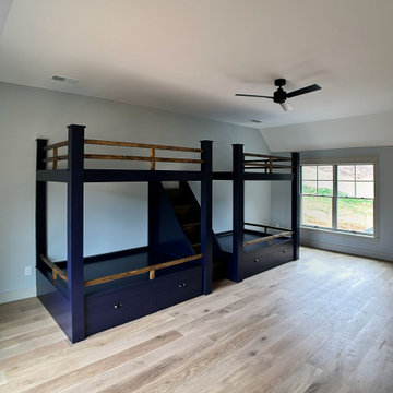 Spacious Shared Kids Room with Custom Bunk Beds, Integrated Drawers, and Vaulted