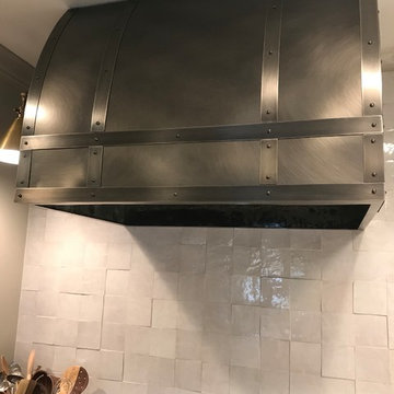 This was a small steel vent hood with a oxidized look and accent straps to accom