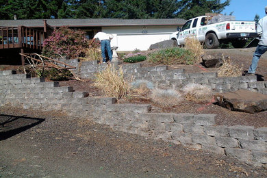Design ideas for a mid-sized full sun hillside concrete paver landscaping in Other for winter.