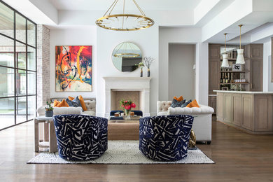Huge trendy open concept medium tone wood floor living room photo in Houston with a bar, white walls, a standard fireplace, a stone fireplace and no tv