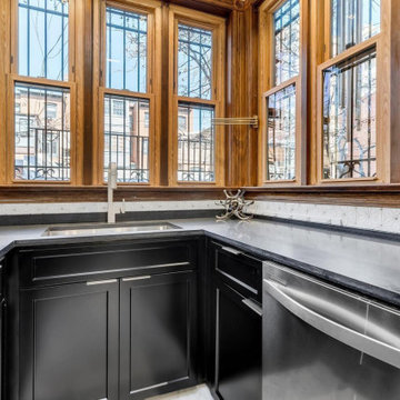 Two-Toned White and Dark Hunter Green Cabinets with Black Quartz Countertop