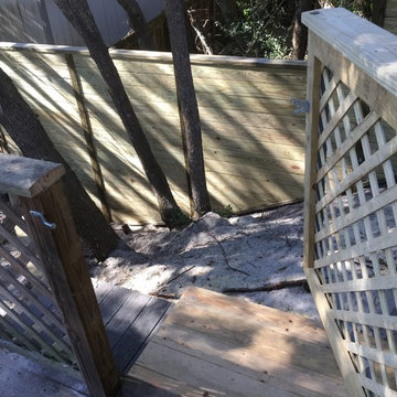 Lattice gate set in a aluminum frame alongside a lateral fence offset with 4by6s