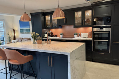 Dark charcoal shaker kitchen with copper accessories