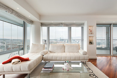 Inspiration for a large contemporary formal and open concept medium tone wood floor living room remodel in Barcelona with beige walls, no fireplace and a wall-mounted tv