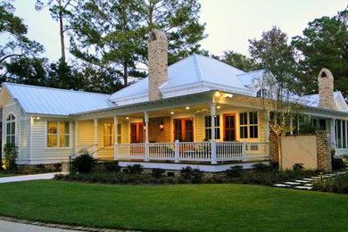 Example of a mid-sized classic green one-story wood exterior home design in Miami with a hip roof