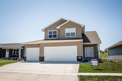 Inspiration for a mid-sized timeless beige two-story vinyl exterior home remodel in Cedar Rapids