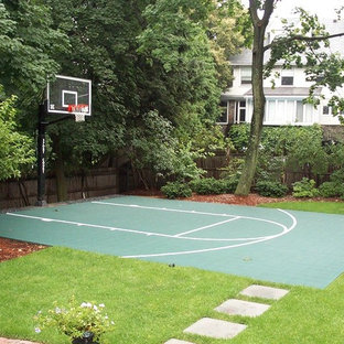 This is an example of a small traditional backyard partial sun outdoor sport court in Boston with concrete pavers.