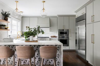 Design ideas for a mid-sized transitional u-shaped separate kitchen in San Francisco with a farmhouse sink, raised-panel cabinets, grey cabinets, marble benchtops, white splashback, marble splashback, stainless steel appliances, medium hardwood floors, a peninsula, brown floor and white benchtop.