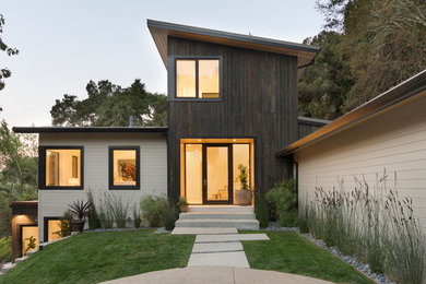 Inspiration for a mid-sized contemporary brown three-story mixed siding house exterior remodel in San Francisco with a shed roof and a metal roof