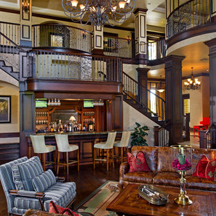 Design ideas for a large mediterranean open plan living room in Orlando with a home bar, beige walls, dark hardwood flooring and brown floors.