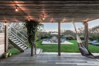 Example of a large trendy backyard patio design in New York with a fire pit