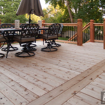 Leeder - Cedar deck in Kansas City with stamped concrete patio and firepit.