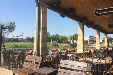 Patio - large traditional courtyard patio idea in Dallas with a roof extension