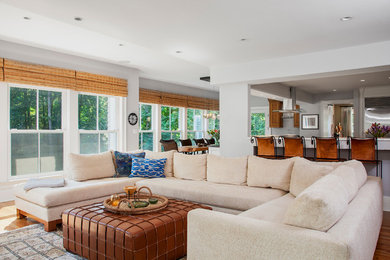 Example of a mid-sized transitional open concept dark wood floor and brown floor family room design in New York with gray walls, a standard fireplace, a stone fireplace and a wall-mounted tv