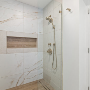Warm Transitional Two-Room Primary Bathroom