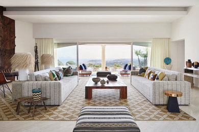 Photo of an expansive beach style formal open concept living room with white walls, travertine floors and beige floor.