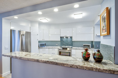 Inspiration for a large contemporary eat-in kitchen in Hawaii with a single-bowl sink, flat-panel cabinets, white cabinets, quartzite benchtops, blue splashback, mosaic tile splashback, stainless steel appliances, vinyl floors and grey floor.