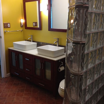 Furniture grade cabinetry vessel sinks and a curved glass block wall