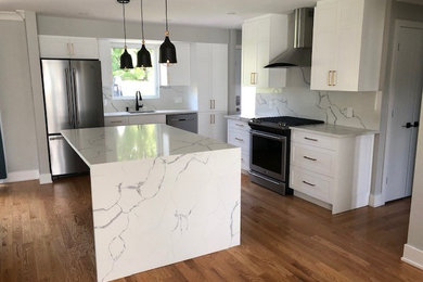 Inspiration for a mid-sized contemporary l-shaped medium tone wood floor and brown floor eat-in kitchen remodel in Ottawa with an undermount sink, shaker cabinets, white cabinets, wood countertops, white backsplash, stone slab backsplash, stainless steel appliances, an island and white countertops