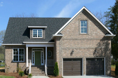 Mid-sized transitional brown two-story brick exterior home idea in Other