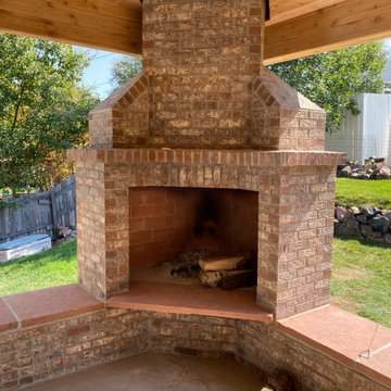 Patio roof cover with brick fireplace.