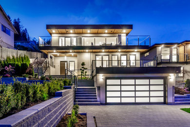 Photo of a modern stucco house exterior in Vancouver with a flat roof.