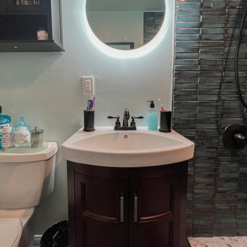 Laguna Hills Bathroom Remodel with Rich Wood Vanity and Backlit Mirror Accent