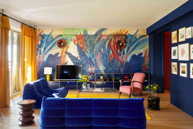 На фото: большая изолированная гостиная комната в стиле фьюжн с разноцветными стенами, паркетным полом среднего тона, отдельно стоящим телевизором, коричневым полом и обоями на стенах без камина с