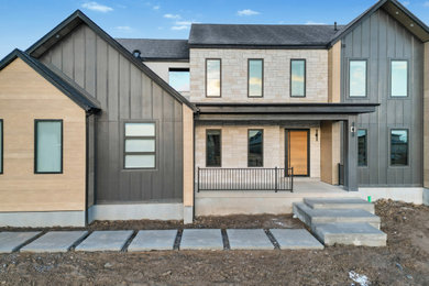 Inspiration for a large transitional black three-story concrete fiberboard and board and batten house exterior remodel in Salt Lake City with a hip roof, a shingle roof and a black roof