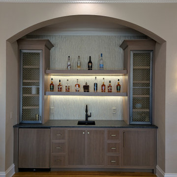 Rift cut white oak bar with custom metal mesh doors and reeded panels