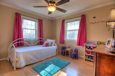 Example of a small classic guest medium tone wood floor bedroom design in Richmond with beige walls