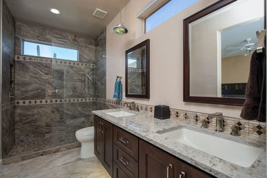 Example of a large transitional 3/4 brown tile and porcelain tile porcelain tile and multicolored floor bathroom design in Phoenix with shaker cabinets, dark wood cabinets, beige walls, an undermount sink and granite countertops