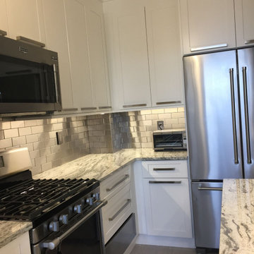 White Kitchens with Stainless Steel Backsplash