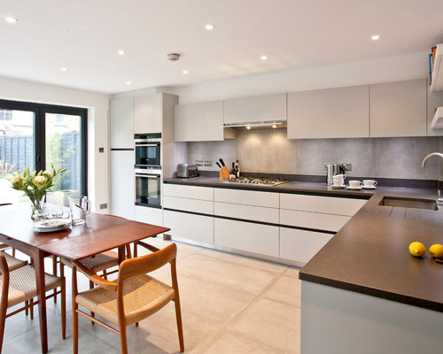 Concrete Splashback Home Design Ideas, Renovations & Photos Photo of a contemporary l-shaped eat-in kitchen in Surrey with an undermount