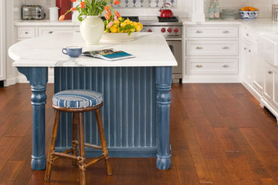Enclosed kitchen - large mediterranean l-shaped medium tone wood floor enclosed kitchen idea in New York with a farmhouse sink, glass-front cabinets, white cabinets, marble countertops, multicolored backsplash, cement tile backsplash, stainless steel appliances and an island