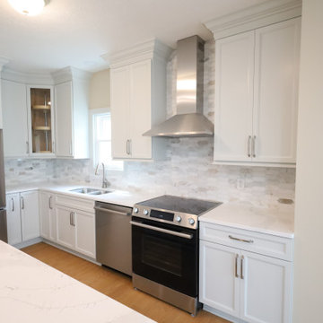 Sleek & Sophisticated: Gray Kitchen Remodel with Quartz Countertops, Marble Back
