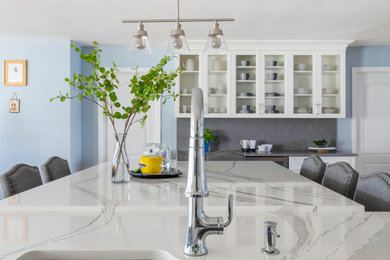Eat-in kitchen - mid-sized transitional medium tone wood floor eat-in kitchen idea in New York with an undermount sink, beaded inset cabinets, white cabinets, quartz countertops, multicolored backsplash, quartz backsplash, stainless steel appliances, an island and multicolored countertops