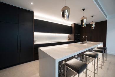 This is an example of a contemporary kitchen in Adelaide with quartz benchtops and with island.