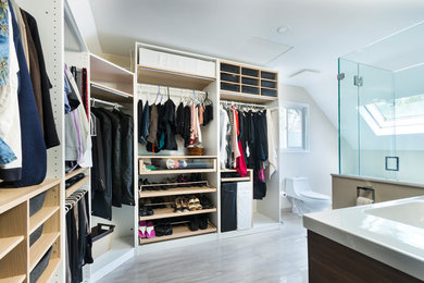 Walk-in closet - mid-sized contemporary gender-neutral porcelain tile and gray floor walk-in closet idea in Vancouver with open cabinets and light wood cabinets