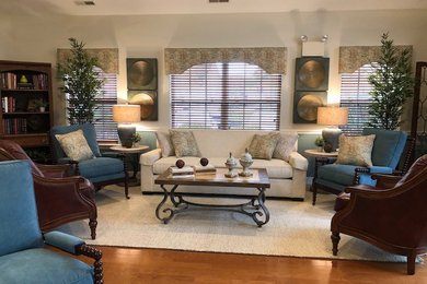 Inspiration for a huge coastal open concept medium tone wood floor, brown floor and vaulted ceiling family room library remodel in Philadelphia with beige walls, a standard fireplace, a brick fireplace and a wall-mounted tv
