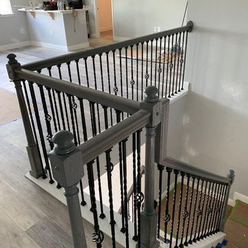 Gray staircase done with basket and double twist iron spindles