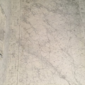 8mm thin slab white Carrara mable shower with matching caddy, tile, pencil trim