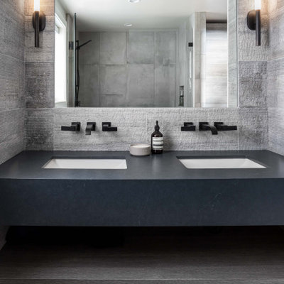Bathroom - mid-sized contemporary 3/4 beige tile and cement tile porcelain tile, beige floor and double-sink bathroom idea in Sacramento with flat-panel cabinets, light wood cabinets, a one-piece toilet, white walls, an undermount sink, quartz countertops, a hinged shower door, blue countertops and a floating vanity
