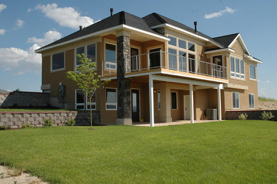 Example of a mid-sized classic beige one-story stucco house exterior design in Boise with a hip roof and a shingle roof